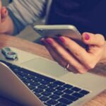 woman holding silver iphone